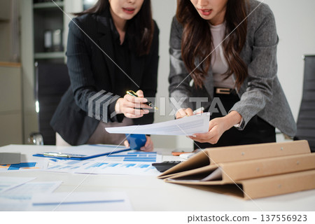 Business team collaboration discussing working analyzing with financial data and marketing growth report graph in team, presentation and digital tablet, laptop. 137556923