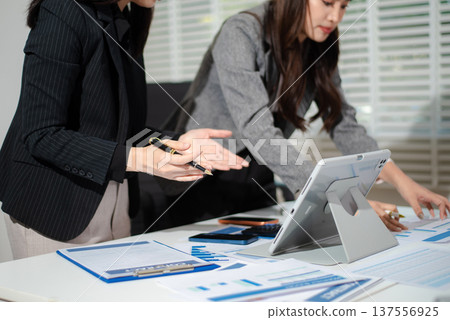 Business team collaboration discussing working analyzing with financial data and marketing growth report graph in team, presentation and digital tablet, laptop. 137556925