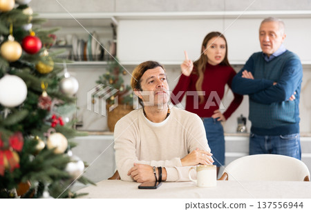 Man and woman quarreling with man 137556944