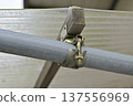 Close-up structural image of a rafter clamp that secures single-pipe pipes and timber (rafters) 137556969