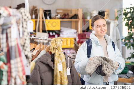 Teenage girl choosing a fur hat 137556991