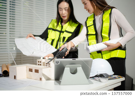 Business people having consultation about wind energy at company office. Asian industry professional team. Business people having consultation about wind energy at company office. Asian industry professional team. 137557000
