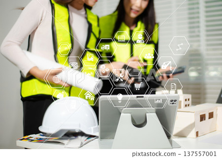Engineer teams meeting working together wear worker helmets hardhat on construction site in modern city. Engineer teams meeting working together wear worker helmets hardhat on construction site in modern city. 137557001