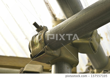 Close-up of single pipe and orthogonal clamp at construction site 137557105