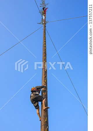 Traditional ladder climbing activity, climbers ascend step by step. Traditional ladder climbing activity, climbers ascend step by step. 137557211
