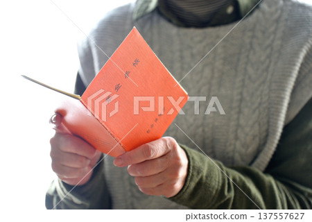 Seniors checking their pension book 137557627