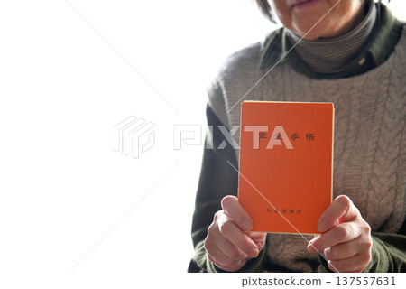 Seniors checking their pension book Seniors checking their pension book 137557631