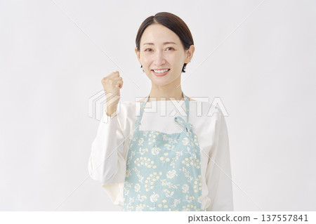Woman wearing an apron, fist pump, white background Woman wearing an apron, fist pump, white background 137557841