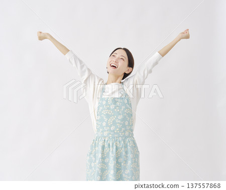 Woman wearing an apron stretching white background 137557868