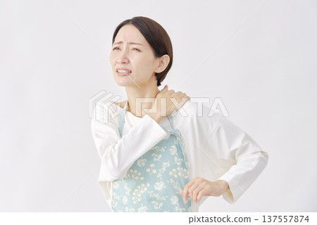 Woman wearing an apron, stiff shoulders, white background Woman wearing an apron, stiff shoulders, white background 137557874