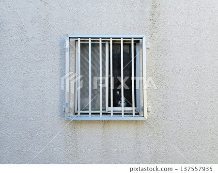Security grill installed over a residential window on wall in Japanese style 137557935