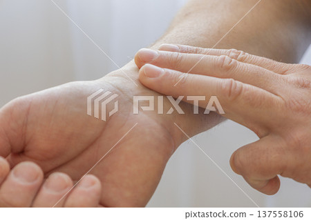Checking Pulse On Wrist With Fingers Checking Pulse On Wrist With Fingers 137558106
