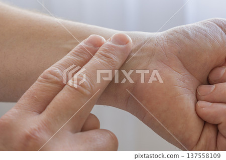 Checking Pulse On Wrist With Fingers Checking Pulse On Wrist With Fingers 137558109