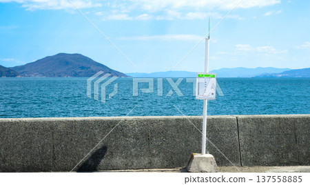 A bus stop on Shodoshima with a clear blue sky and the Seto Inland Sea in the background A bus stop on Shodoshima with a clear blue sky and the Seto Inland Sea in the background 137558885