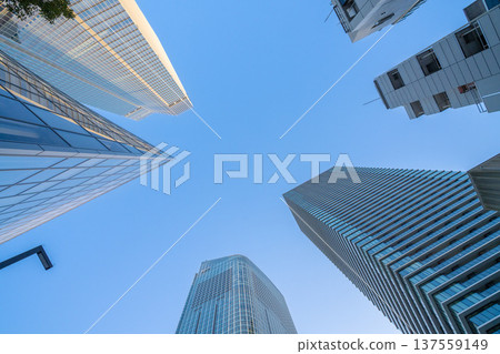 Redevelopment area in Minato Ward, Tokyo: Skyscrapers and office buildings towering into the blue sky 137559149