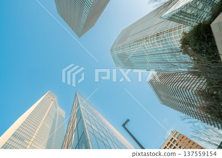 Redevelopment area in Minato Ward, Tokyo: Skyscrapers and office buildings towering into the blue sky 137559154