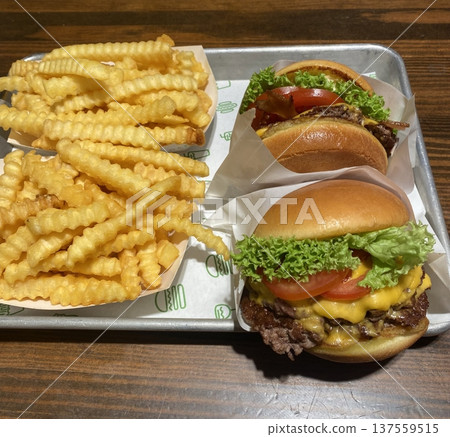 A classic combination of a juicy burger with fresh toppings served alongside golden, crispy French fries. Perfect for a satisfying meal that blends savory flavors and crunchy textures. A classic combination of a juicy burger with fresh toppings served alongside golden, crispy French fries. Perfect for a satisfying meal that blends savory flavors and crunchy textures. 137559515