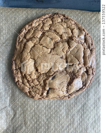 Freshly baked cookies with a golden-brown finish and chocolate chips. Perfectly crisp on the edges with a soft center, offering a delicious, comforting treat for any occasion. 137559522