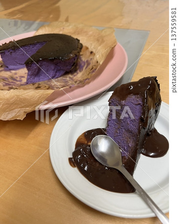 Rich and velvety chocolate cheesecake slice with a smooth, creamy texture and deep cocoa flavor. A perfect balance of indulgence and sweetness for a decadent dessert experience. 137559581