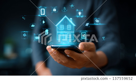Smart home control interface with glowing house hologram and connected device icons, user operating smartphone with tech feel Smart home control interface with glowing house hologram and connected device icons, user operating smartphone with tech feel 137559652