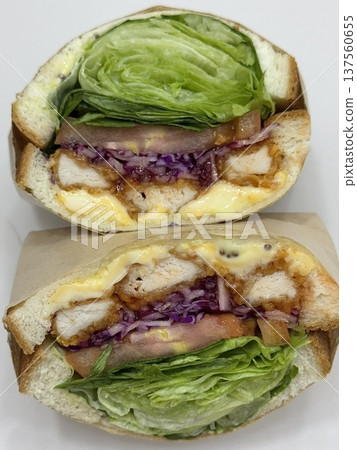Delicious sandwich filled with fresh ingredients like crisp vegetables, tender meats, and savory spreads, all between two slices of soft bread. Perfect for a quick and satisfying meal. Delicious sandwich filled with fresh ingredients like crisp vegetables, tender meats, and savory spreads, all between two slices of soft bread. Perfect for a quick and satisfying meal. 137560655