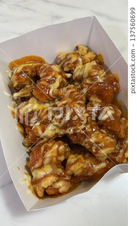 Crispy Korean fried chicken, perfectly glazed with a sweet and spicy sauce. Ideal for food photography and menus, showcasing the irresistible crunch and flavor of this beloved dish. Crispy Korean fried chicken, perfectly glazed with a sweet and spicy sauce. Ideal for food photography and menus, showcasing the irresistible crunch and flavor of this beloved dish. 137560699