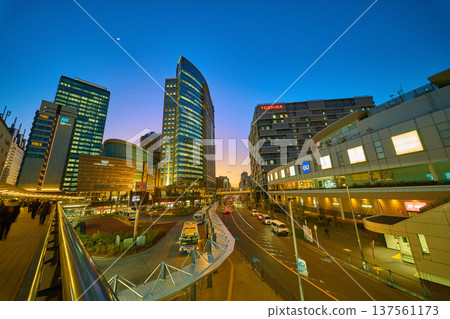 View of the evening and night view of commercial facilities around the west exit of Kawasaki Station in Kawasaki City, Kanagawa Prefecture (skyscrapers, crescent moon) 137561173
