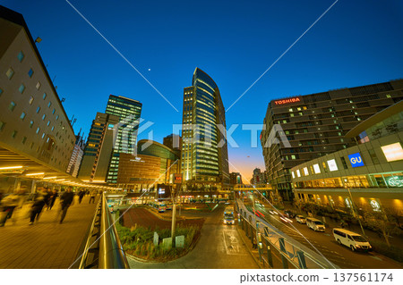 View the night view of commercial facilities (skyscrapers, crescent moon) around the west exit of Kawasaki Station in Kawasaki City, Kanagawa Prefecture 137561174