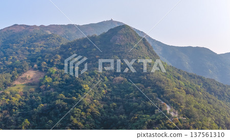 Kwun Yam Shan forested peak rising beneath clear sky March 7 2026 Kwun Yam Shan forested peak rising beneath clear sky March 7 2026 137561310