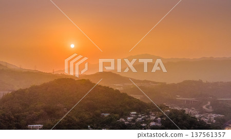 Tai Po mountains glowing under warm golden sunset sky March 7 2026 Tai Po mountains glowing under warm golden sunset sky March 7 2026 137561357