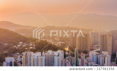 Tai Po skyline with mountains under warm sunset light March 7 2026 Tai Po skyline with mountains under warm sunset light March 7 2026 137561358