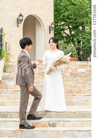 Bride and groom descending the chapel stairs at their wedding (bridal, wedding, reception) Bride and groom descending the chapel stairs at their wedding (bridal, wedding, reception) 137561686