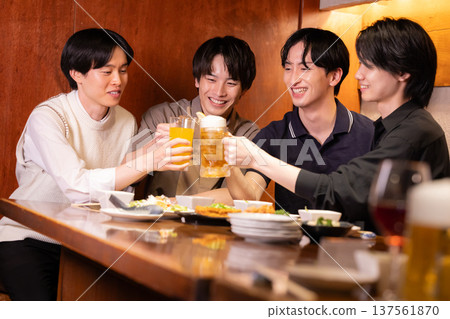 Drinking party: Young people toasting with various drinks at an izakaya 137561870