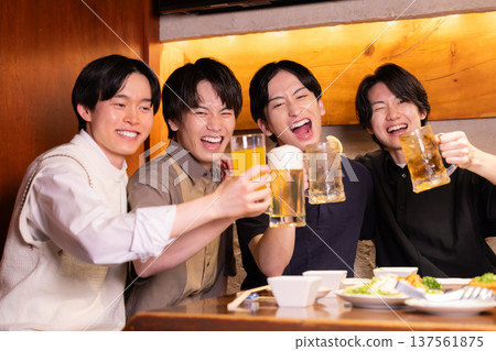Drinking party: Young people toasting with various drinks at an izakaya Drinking party: Young people toasting with various drinks at an izakaya 137561875