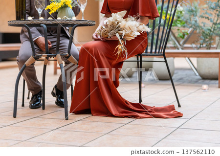 Couple in dresses sitting on chairs, married couple, bride and groom, dressed up couple, millionaire, wealthy Couple in dresses sitting on chairs, married couple, bride and groom, dressed up couple, millionaire, wealthy 137562110