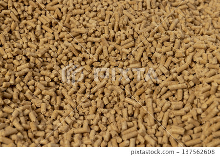 a large number of cylindrical fuel pellets made from sawdust of coniferous or pine trees, the pellets are used both for indoor heating and for bedding for pets, wood pellets a large number of cylindrical fuel pellets made from sawdust of coniferous or pine trees, the pellets are used both for indoor heating and for bedding for pets, wood pellets 137562608