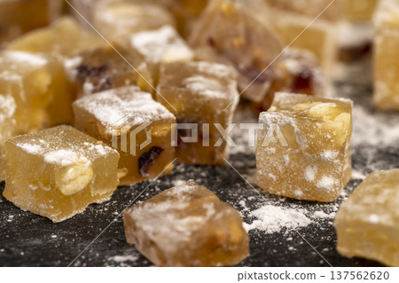 soft and fresh Turkish delight sprinkled with a small amount of powdered white sugar, sweet white soft pieces of Turkish delight with nuts and dried fruits, yellow-orange sweetness soft and fresh Turkish delight sprinkled with a small amount of powdered white sugar, sweet white soft pieces of Turkish delight with nuts and dried fruits, yellow-orange sweetness 137562620