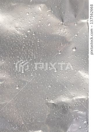 wet new aluminum foil with a lot of water on the surface, aluminum foil for food packaging with a large number of drops of clean water 137562668