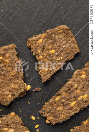 thin natural hard dry rye flour loaves with flax seeds and wheat fiber, natural healthy loaves from a complex of ingredients for dietary thin natural hard dry rye flour loaves with flax seeds and wheat fiber, natural healthy loaves from a complex of ingredients for dietary 137562672