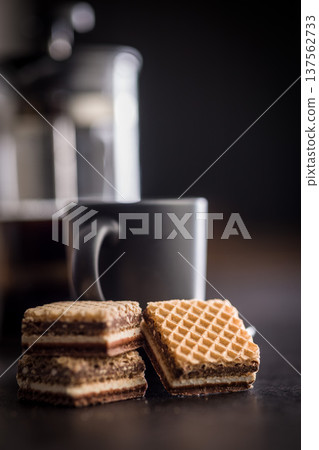 Stacked Chocolate Wafer Cookies With Coffee Mug on Dark Tableto. Sweet Snack Dessert Stacked Chocolate Wafer Cookies With Coffee Mug on Dark Tableto. Sweet Snack Dessert 137562733