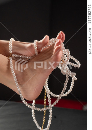 Foot fetish. Bare female feet with pearl beads. Foot fetish. Bare female feet with pearl beads. 137562761