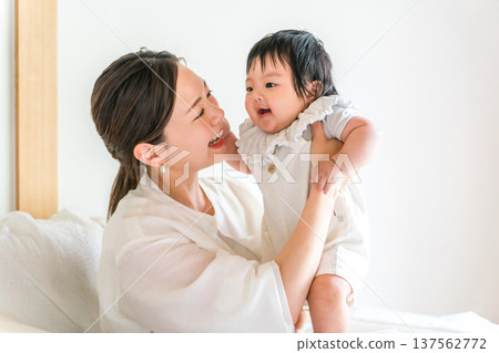 Mother holding a baby, mom (childcare, full-time housewife) Mother holding a baby, mom (childcare, full-time housewife) 137562772