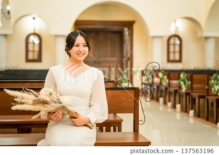 Wedding hall, bride sitting on a bench in the chapel, bride (aisin road, church, chapel) Wedding hall, bride sitting on a bench in the chapel, bride (aisin road, church, chapel) 137563196