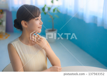 A woman taking care of her neck by the window: Happy Pop 137563352