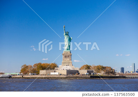 Statue of Liberty on Liberty Island with clear blue sky in New York Harbor 137563500
