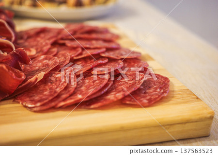 Iberian chorizo slices on wooden board close-up Spanish cured sausage Iberian chorizo slices on wooden board close-up Spanish cured sausage 137563523