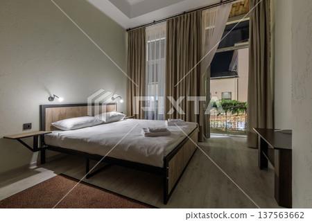Modern Hostel Room with Double Bed and Festive Balcony View 137563662