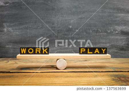 WORK PLAY Balance Concept Shown On Wooden Seesaw With Letter Blocks WORK PLAY Balance Concept Shown On Wooden Seesaw With Letter Blocks 137563699