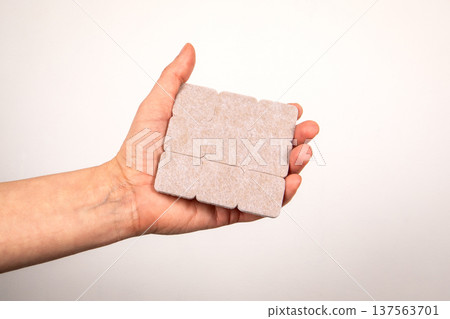 Hand Holding Square Adhesive Felt Pads For Furniture Floor Protection Hand Holding Square Adhesive Felt Pads For Furniture Floor Protection 137563701