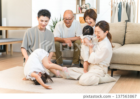 Children and parents, grandchildren and grandparents, family performing somersaults 137563867